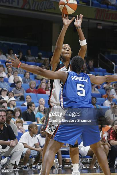 Mery Andrade of the Cleveland Rockers passes up over Elaine Powell of the Orlando Miracle in the game on June 19, 2002 at Gund Arena in Cleveland,...