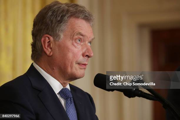 Finnish President Sauli Niinisto rolls his eyes during a joint news conference with U.S. President Donald Trump in the East Room of the White House...