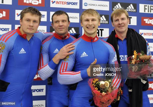 Russia's Alexander Zoubkov and his team Roman Orechnikov, Dimitry Trunenkov and Dimitry Stepushkin celebrate their victory on the podium in...