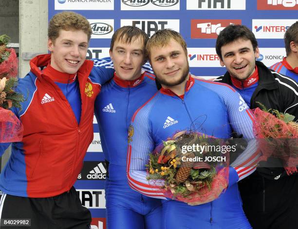 Russia's Petr Moiseev, Andrey Jurkov, Dmitry Abramovitch and Philipp Egorov celebrate their third place on the podium in Innsbruck/Igls during a...