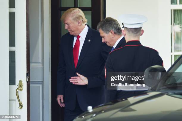 President Donald Trump, left, greets Sauli Niinisto, Finland's president, center, at the entrance to the White House in Washington, D.C., U.S., on...