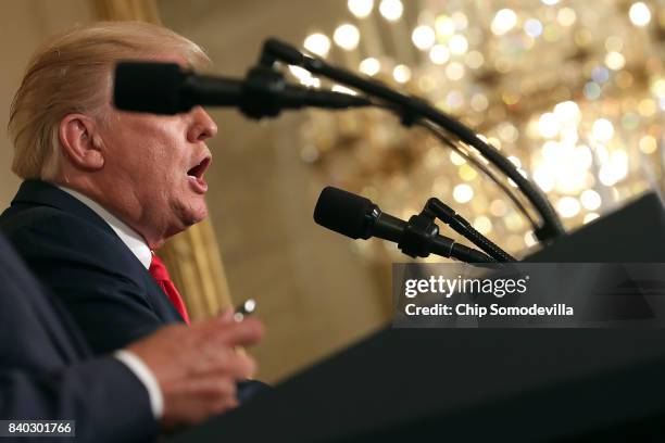 President Donald Trump answers reporters' questions during a joint news conference with Finnish President Sauli Niinisto in the East Room of the...