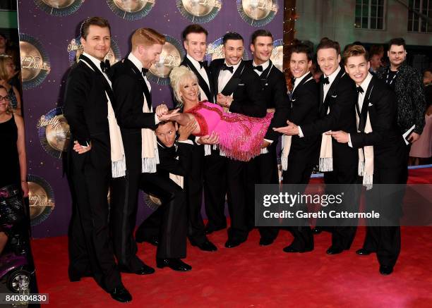 Contestant Debbie McGee is held by male dancers Pasha Kovalev, Neil Jones, Brendan Cole, Anton du Beke, Giovanni Pernice, Aljaz Skorjanec, Gorka...