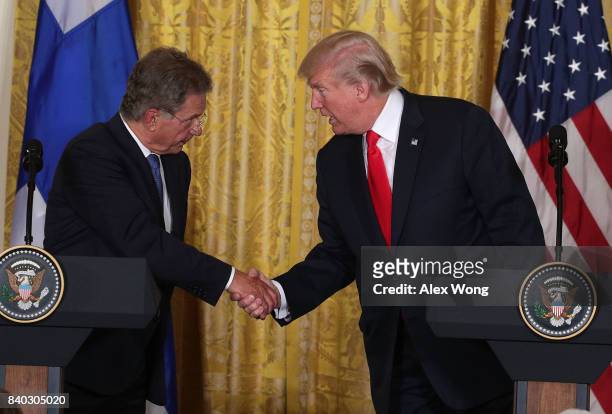 President Donald Trump and President Sauli Niinisto of Finland shake hands during a joint news conference at the East Room of the White House August...