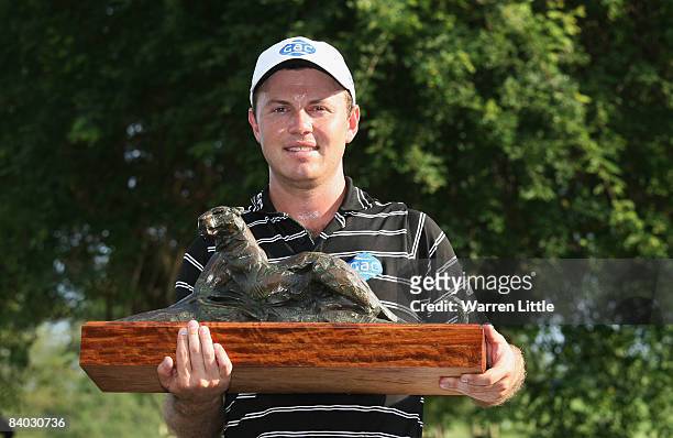 Richard Sterne of South Africa poses with the trophy after winning the Alfred Dunhill Championship with a score of -17 under par at Leopard Creek...