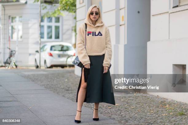 Sonia Lyson wearing a beige fleece fake teddy cropped Fila hoody, velvet pumps Jimmy Choo, black green KAN I Fendi bag, a fendi skirt, Ray Ban...