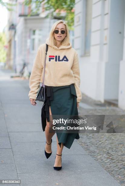 Sonia Lyson wearing a beige fleece fake teddy cropped Fila hoody, velvet pumps Jimmy Choo, black green KAN I Fendi bag, a fendi skirt, Ray Ban...