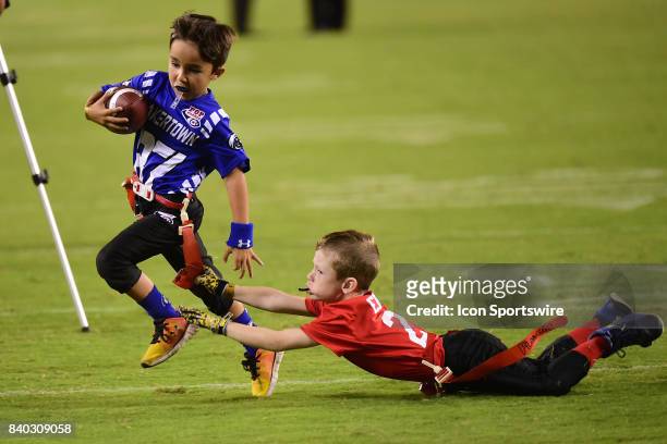 Local children participate in flag football at half time during a NFL preseason game between the Miami Dolphins and the Philadelphia Eagles on August...