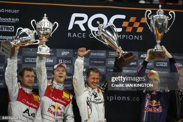 German Sebastian Vettel and German Michael Schumacher lift their trophy after winning the Nations Cup event next to second placed Sweden's Mattias...