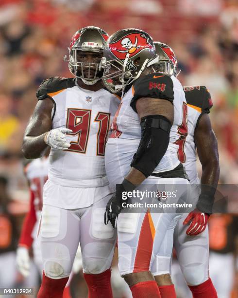 Tampa Bay Buccaneers defensive end Robert Ayers Jr. Speaks to Tampa Bay Buccaneers defensive tackle Chris Baker during an NFL preseason football game...