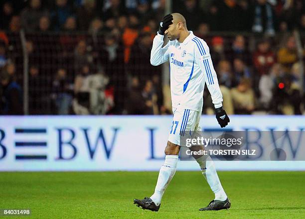 Schalke's Dutch midfielder Orlando Engelaar walks off the pitch after receiving a Red Card leaving Schalke with only 9 men after midfielder Jermaine...