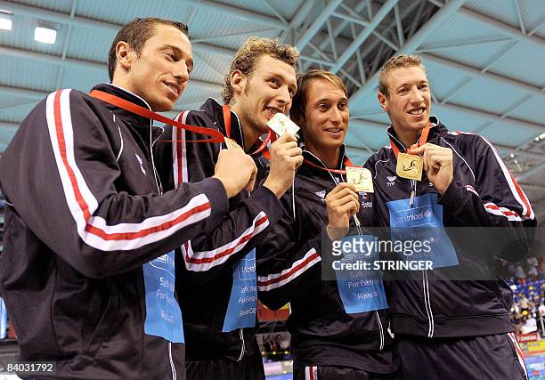 French team : Alain Bernard, Fabien Gilot, Amaury Leveaux and Frederick Bousquet pose with gold medals after winning men's 4x50m freestyle race with...