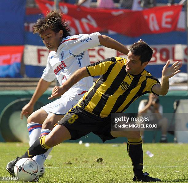 Nacional's Martin Liguera vies for the ball with Penarol's Antonio Pacheco during the traditional big game of the Uruguayan tournament at the...