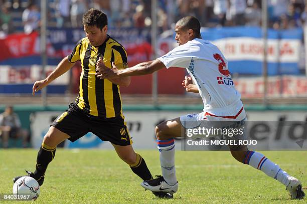 Nacional's Diego Arismendi vies for the ball with Penarol's Antonio Pacheco during the traditional big game of the Uruguayan tournament at the...