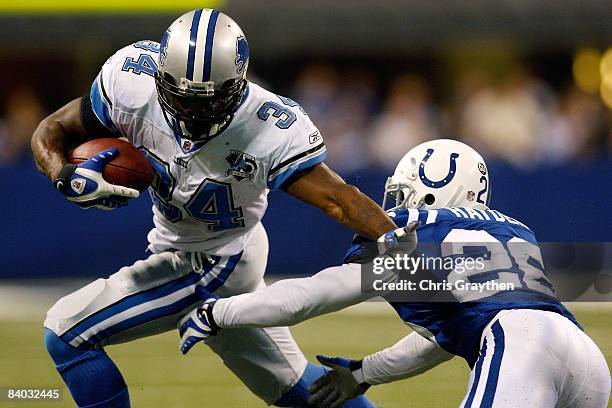 Kevin Smith of the Detroit Lions avoids a tackle by Kelvin Hayden of the Indianapolis Colts on December 14, 2008 at Lucas Oil Stadium in...