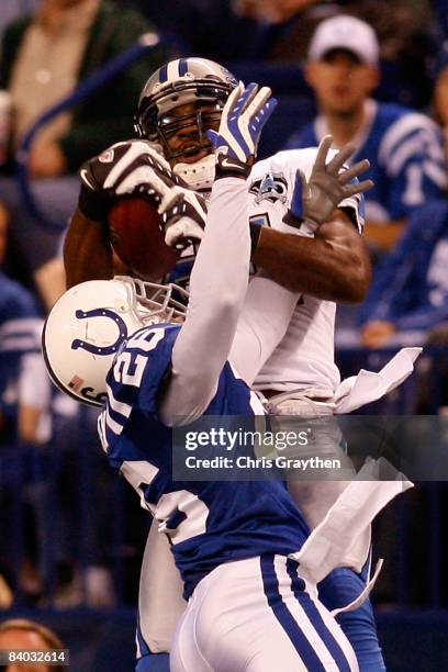 Calvin Johnson of the Detroit Lions makes a catch over Kelvin Hayden of the Indianapolis Colts on December 14, 2008 at Lucas Oil Stadium in...