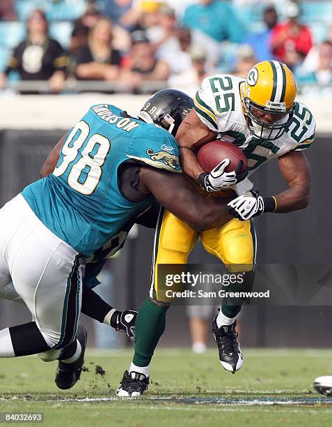 John Henderson of the Jacksonville Jaguars tackles Ryan Grant of the Green Bay Packers during the game at Jacksonville Municipal stadium on December...