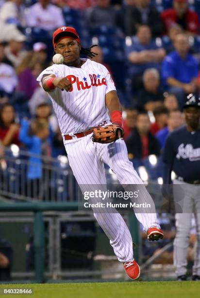 Maikel Franco of the Philadelphia Phillies throws to first base after fielding a ground ball in the third inning during a game against the Atlanta...