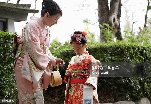 mother and daughter talking in traditional costum - shichi go san stock pictures, royalty-free photos & images