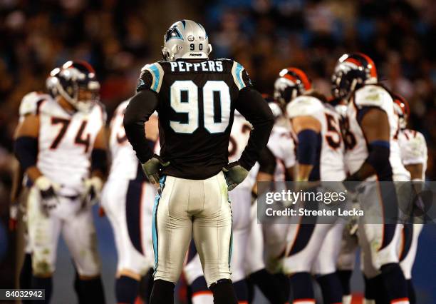 Julius Peppers of the Carolina Panthers waits for the Denver Broncos offense during their game at Bank of America Stadium on December 14, 2008 in...