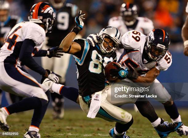 Wesley Woodyard of the Denver Broncos tackles Steve Smith of the Carolina Panthers during their game at Bank of America Stadium on December 14, 2008...