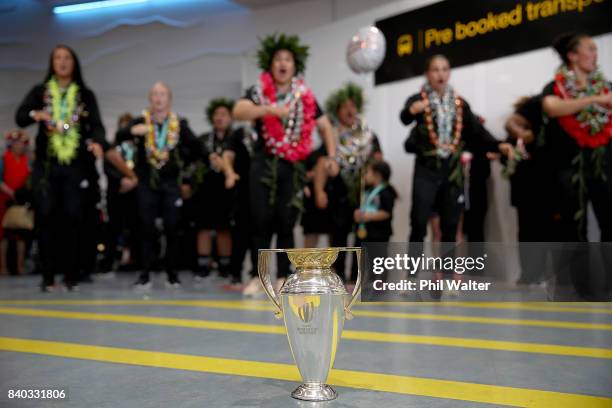 The Black Ferns perform a haka in front of the trophy as the New Zealand Black Ferns arrive at Auckland International Airport on August 29, 2017 in...