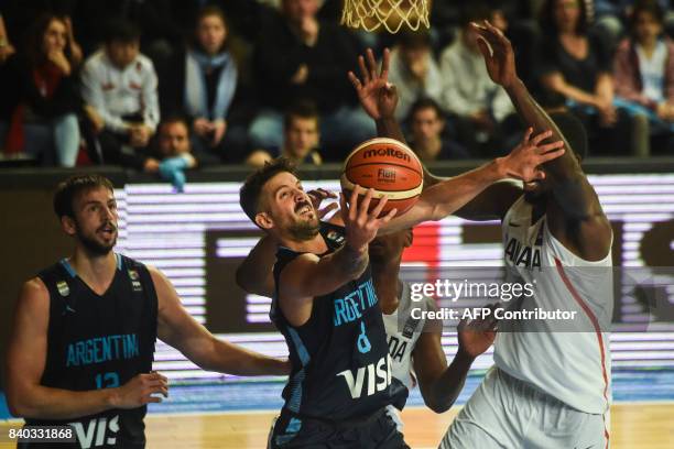 Argentina's point guard Nicolas Laprovittola shoots marked by Canada's power forward Andrew Nicholson during their 2017 FIBA Americas Championship...