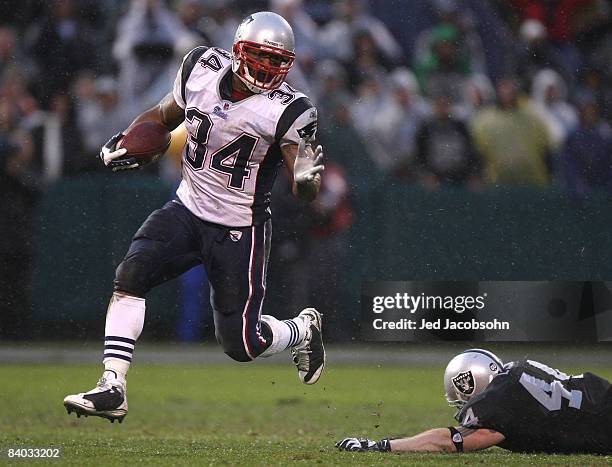 Sammy Morris of the New England Patriots runs against Luke Lawton of the Oakland Raiders during an NFL game on December 14, 2008 at the...
