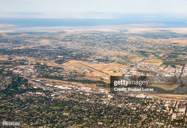 ogden, utah from the air with airport in center of frame - ogden utah stock pictures, royalty-free photos & images