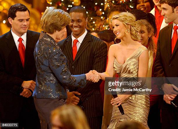 First Lady Laura Bush shakes hands with Julianne Hough on stage during TNT's "Christmas in Washington 2008" at the National Building Museum on...
