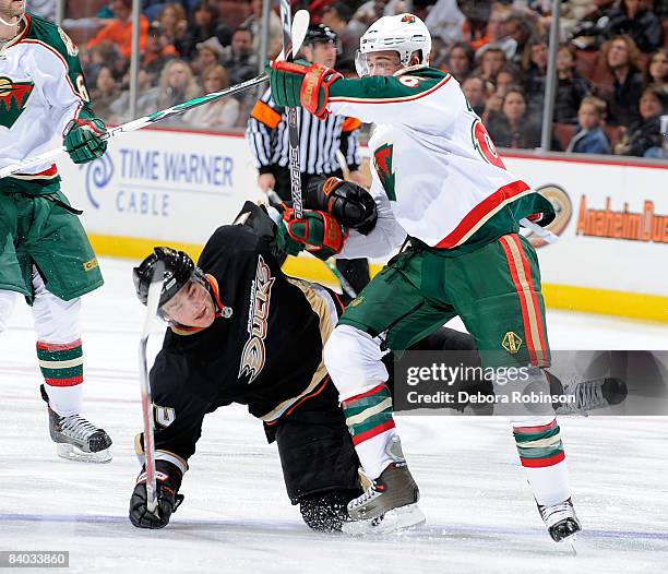 Pierre-Marc Bouchard of the Minnesota Wild gets tangled up with Chris Kunitz of the Anaheim Ducks during the game on December 14, 2008 at Honda...