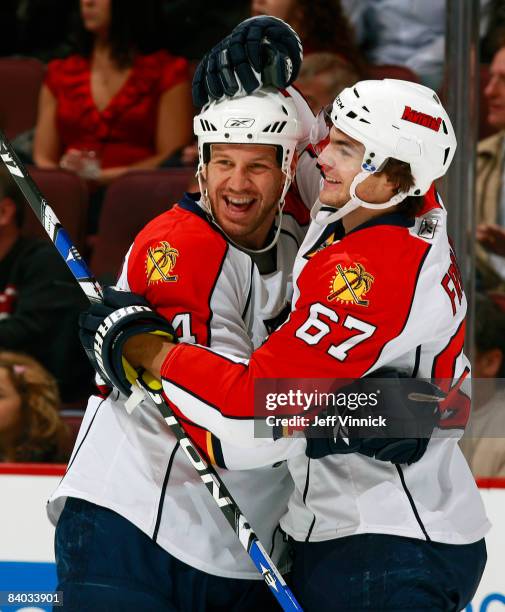 Nick Boynton of the Florida Panthers is congratulated by teammate Michael Frolik after scoring against the Vancouver Canucks at General Motors Place...