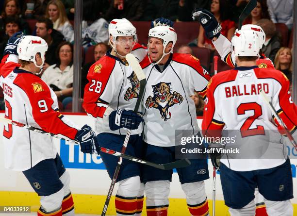 Nick Boynton of the Florida Panthers is congratulated by teammates after scoring against the Vancouver Canucks at General Motors Place on December...