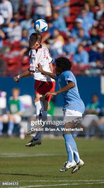 Casey Townsend of the Maryland Terrapins heads the ball away from Sheanon Williams of the North Carolina Tar Heels during second half action at the...