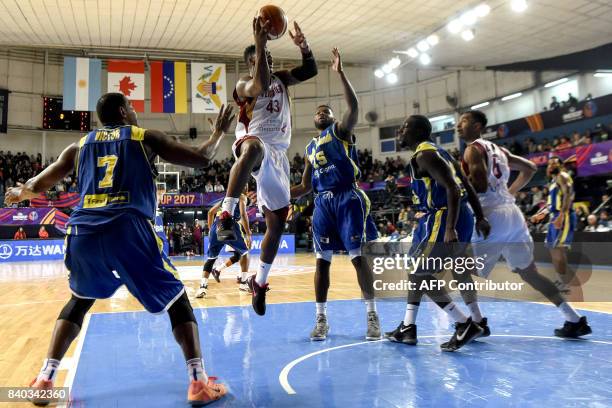 Venezuela's power forward Nestor Colmenares shoots marked by Virgin Islands forward Javier Martinez during their 2017 FIBA Americas Championship...