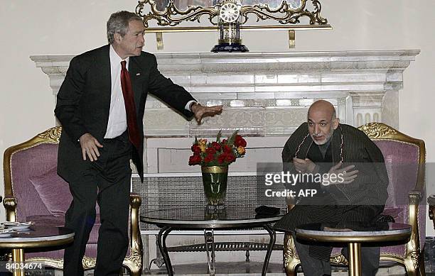 President George W. Bush gestures during a meeting with Afghan President Hamid Karzai at the Presidential Palace in Kabul on December 15, 2008. US...
