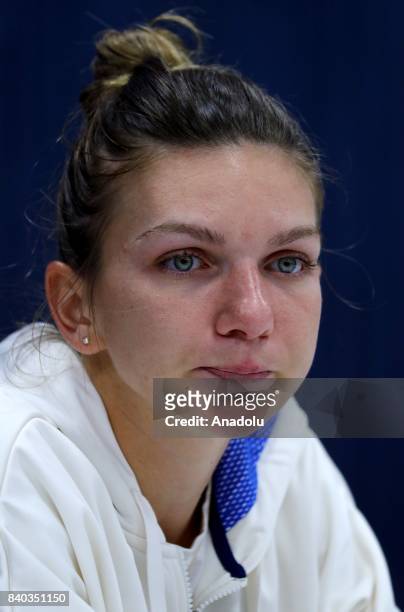 Simona Halep of Romania listens during a press conference held after her Women's Singles tennis match against Maria Sharapova of Russia competes...