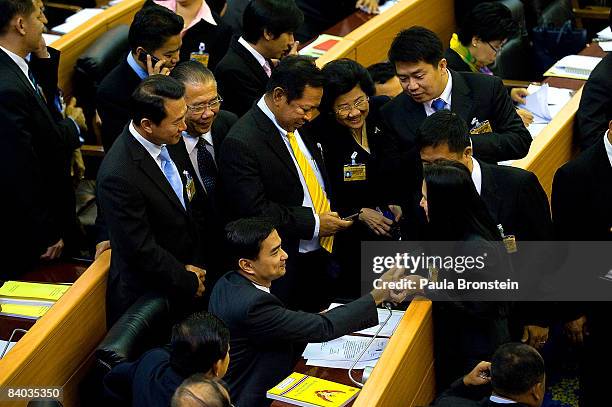 Thai opposition leader Abhisit Vejjajiva greets members of parliament after he won the vote to become Thailand's prime minister on December 15, 2008...