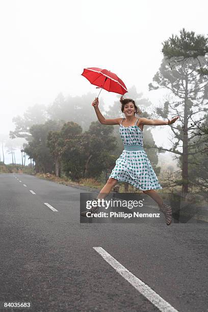 girl on street  jumping with red umbrella - philipp nemenz bildbanksfoton och bilder