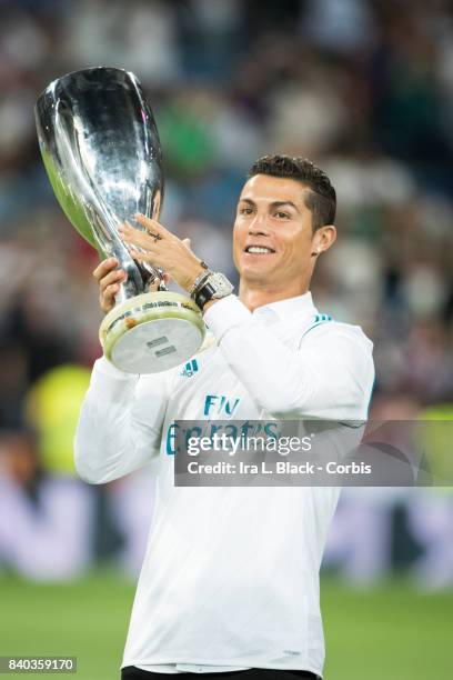 August 27: Cristiano Ronaldo of Real Madrid holds up the UEFA Super Cup trophy prior to the La Liga match between Real Madrid and Valencia C.F. At...