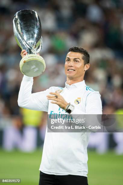 August 27: Cristiano Ronaldo of Real Madrid holds up the UEFA Super Cup trophy prior to the La Liga match between Real Madrid and Valencia C.F. At...