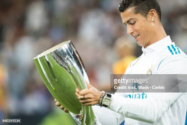 August 27: Cristiano Ronaldo of Real Madrid looks at the UEFA Super Cup trophy prior to the La Liga match between Real Madrid and Valencia C.F. At...