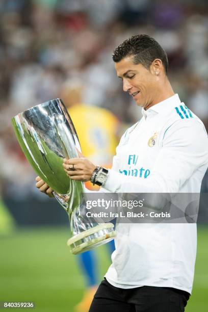 August 27: Cristiano Ronaldo of Real Madrid looks at the UEFA Super Cup trophy prior to the La Liga match between Real Madrid and Valencia C.F. At...