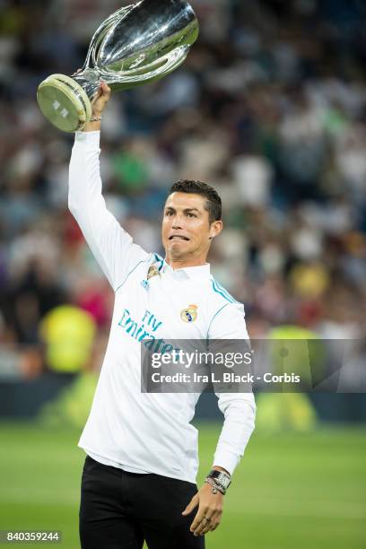 August 27: Cristiano Ronaldo of Real Madrid holds up the UEFA Super Cup trophy prior to the La Liga match between Real Madrid and Valencia C.F. At...