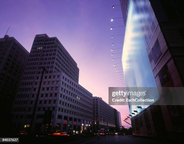 street with offices and gigantic billboard at dusk - berlin billboard stock pictures, royalty-free photos & images