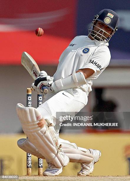 Indian cricketer Sachin Tendulkar reacts from a rising delivery from unseen England cricketer Andrew Flintoff on the fifth and final day of the first...