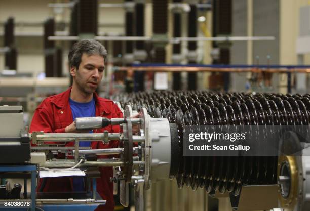 Worker assembles parts for high-voltage circuit breakers at a factory of German engineering company Siemens on December 15, 2008 in Berlin, Germany....