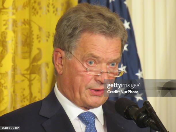 Finnish President Sauli Niinisto rolls his eyes during a joint news conference with U.S. President Donald Trump in the East Room of the White House...