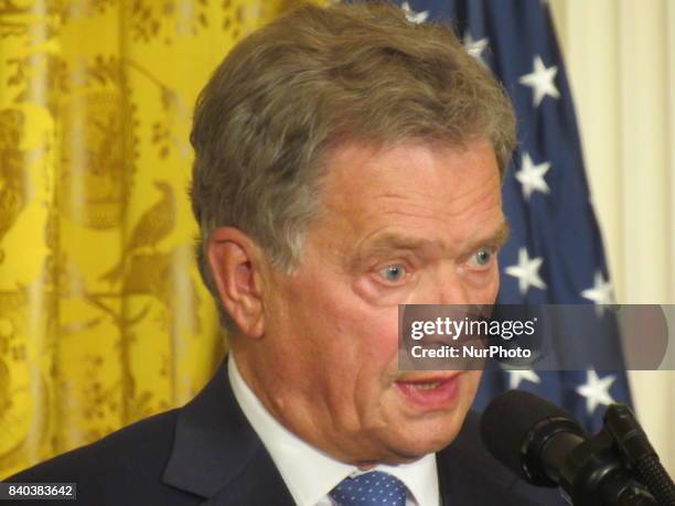 Finnish President Sauli Niinisto rolls his eyes during a joint news conference with U.S. President Donald Trump in the East Room of the White House...