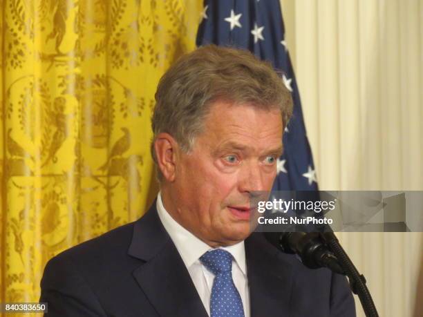 Finnish President Sauli Niinisto rolls his eyes during a joint news conference with U.S. President Donald Trump in the East Room of the White House...